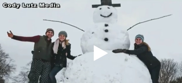 Cody Lutz and his giant snowman on a stump which crashed into a car